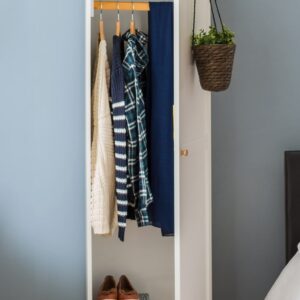 Space-saving wardrobe acting as a room divider in a studio apartment