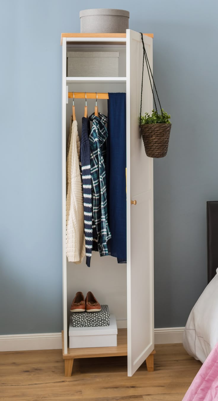 Space-saving wardrobe acting as a room divider in a studio apartment Space-saving wardrobe acting as a room divider in a studio apartment